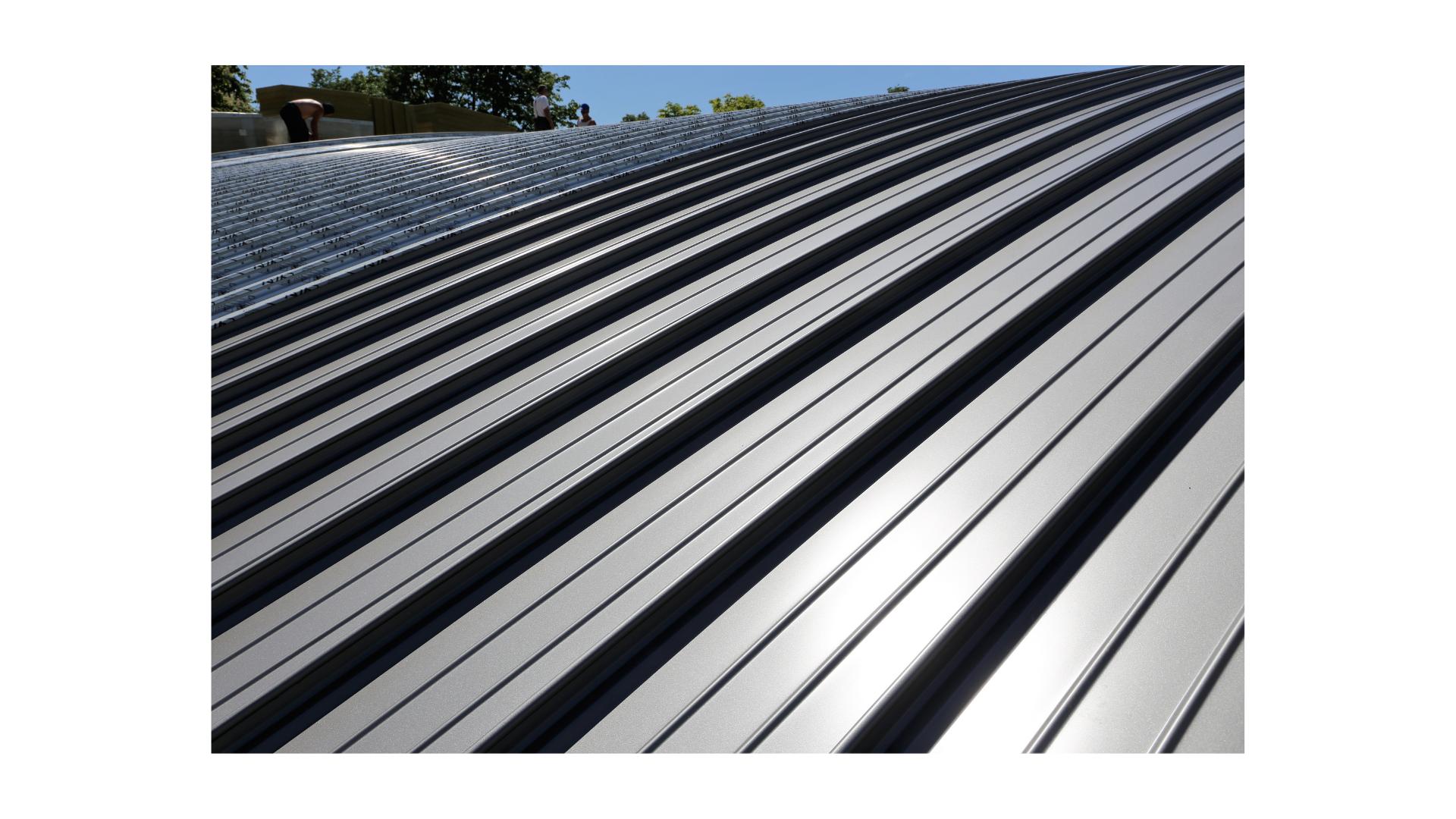 Person installing metal roof systems