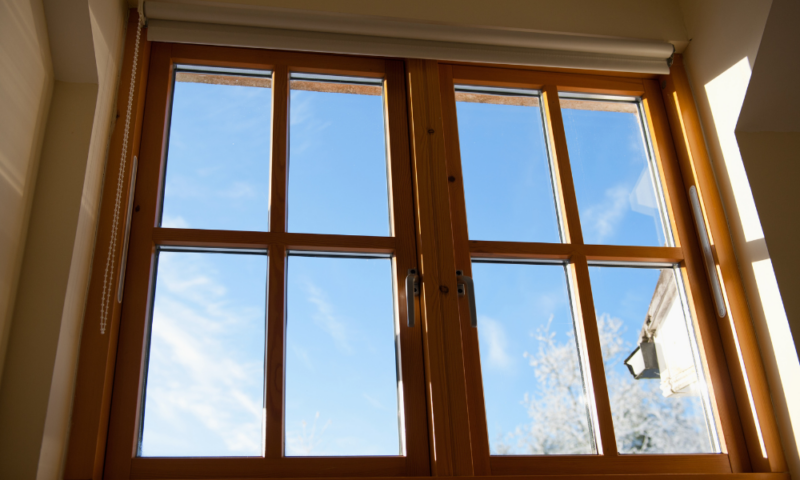 Custom wood-framed window installed by Wolf River Construction, offering energy efficiency and timeless design.