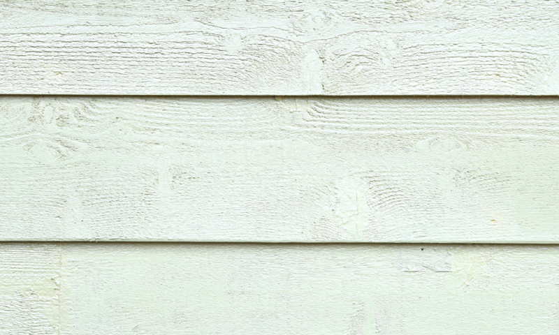 Close-up of wood-textured siding installed by Wolf River Construction, showcasing durable and natural-looking exterior solutions.