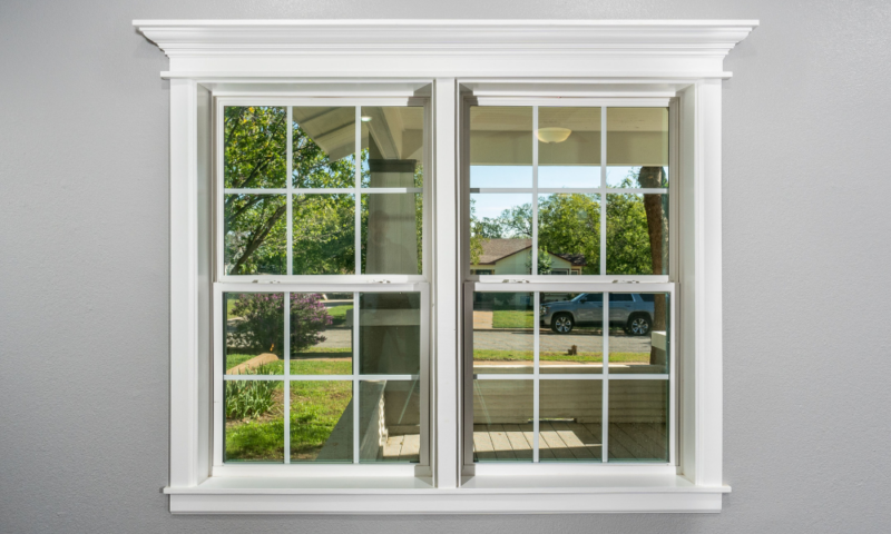 Double-hung window with white trim installed by Wolf River Construction, offering energy efficiency and classic design.