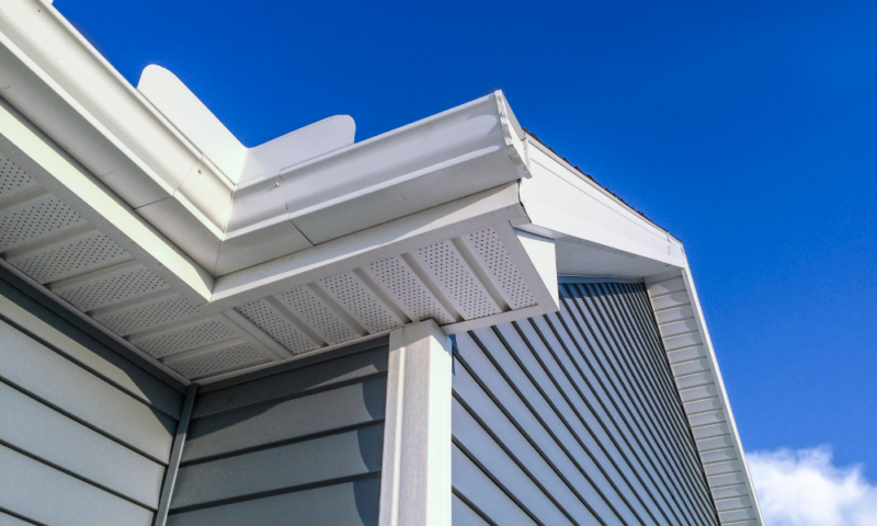 Close-up of soffit, fascia, and blue siding installed by Wolf River Construction, showcasing high-quality exterior craftsmanship.