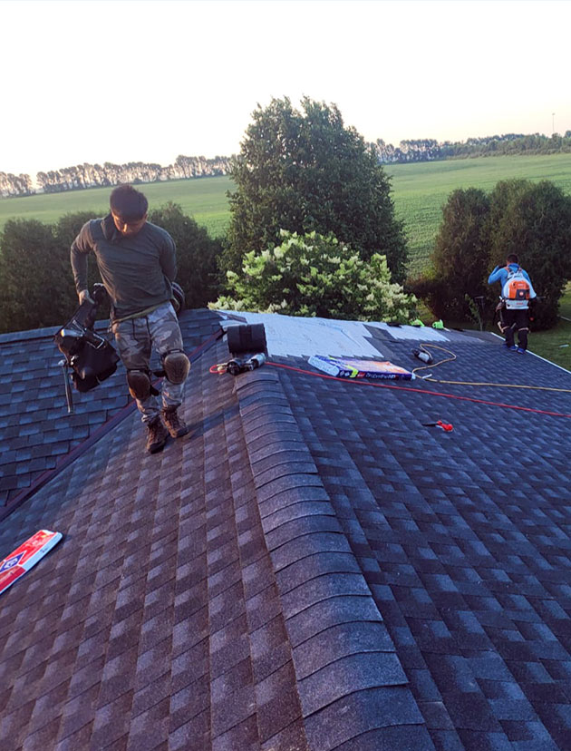 Roofing installation project by Wolf River Construction, showcasing skilled professionals ensuring quality craftsmanship on a residential roof.