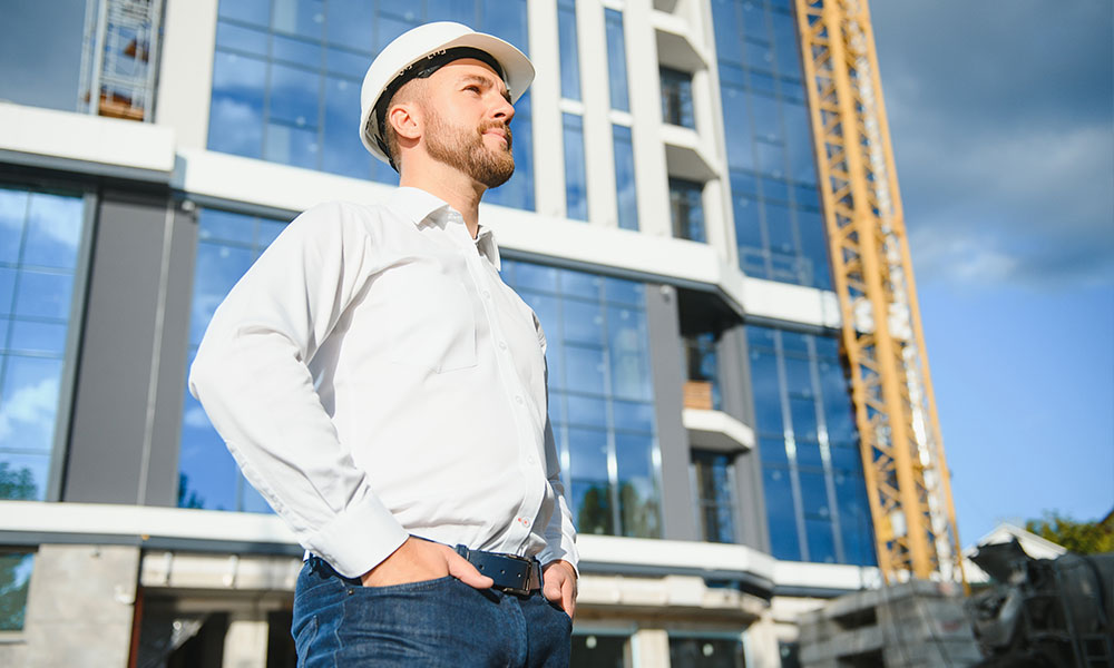 Professional contractor from Wolf River Construction inspecting a modern building project, showcasing expertise in commercial construction.